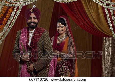 Stock Photograph - Sikh bride and groom standing together . Fotosearch