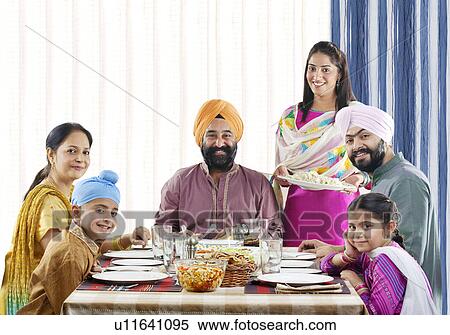 Sikh family having lunch at the dinner table View Large Photo Image Stock Photography - Sikh family having lunch at the dinner table . Fotosearch