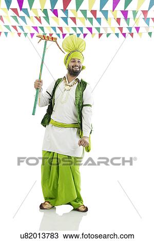 Stock Image - Sikh man holding a Katow . Fotosearch