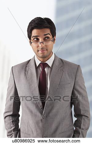 Smart male professional thinking at office View Large Photo Image Stock Photography - Smart male professional thinking at office . Fotosearch