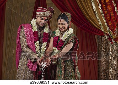 Smiling bride and bridegroom during wedding ceremony View Large Photo Image Stock Image - Smiling bride and bridegroom during wedding ceremony . Fotosearch