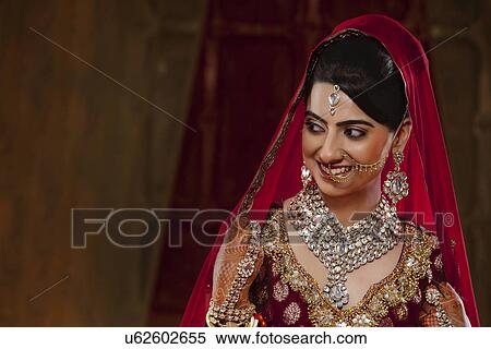Smiling bride in traditional clothing and jewelry View Large Photo Image Stock Photography - Smiling bride in traditional clothing and jewelry . Fotosearch