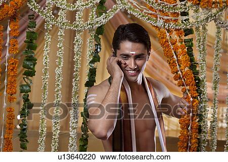 Smiling groom talking on cell phone View Large Photo Image Stock Image - Smiling groom talking on cell phone . Fotosearch