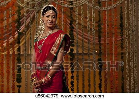 Smiling Indian bride looking away View Large Photo Image Stock Photo - Smiling Indian bride looking away . Fotosearch