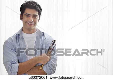 Smiling male painter holding paintbrush View Large Photo Image Stock Image - Smiling male painter holding paintbrush . Fotosearch