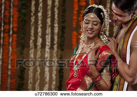 Smiling man fastening wife's necklace View Large Photo Image Stock Image - Smiling man fastening wife's necklace . Fotosearch