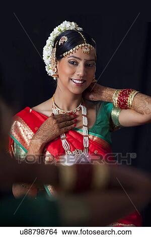 Smiling woman in traditional clothes getting ready View Large Photo Image Picture - Smiling woman in traditional clothes getting ready . Fotosearch