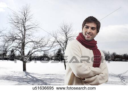 Smiling young man with bare trees in the background View Large Photo Image Stock Photography - Smiling young man with bare trees in the background . Fotosearch