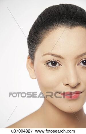 Smiling young woman looking away on white background View Large Photo Image Stock Photo - Smiling young woman looking away on white background . Fotosearch