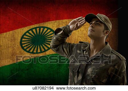 Picture - Soldier saluting with Indian flag in background . Fotosearch