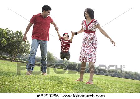 Son having fun with his parents View Large Photo Image Stock Photograph - Son having fun with his parents . Fotosearch