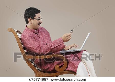 South Indian couple with a laptop and credit card View Large Photo Image Stock Photo - South Indian couple with a laptop and credit card . Fotosearch