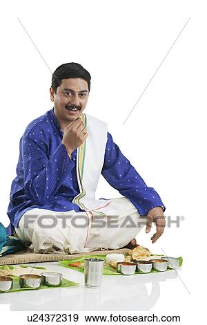 Stock Photo - South Indian man having lunch . Fotosearch