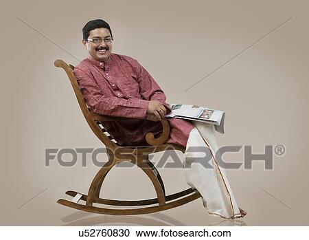 South Indian man sitting on a chair View Large Photo Image Stock Image - South Indian man sitting on a chair . Fotosearch