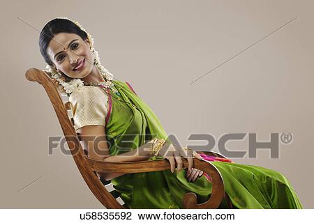 South Indian woman sitting on an arm chair View Large Photo Image Stock Image - South Indian woman sitting on an arm chair . Fotosearch