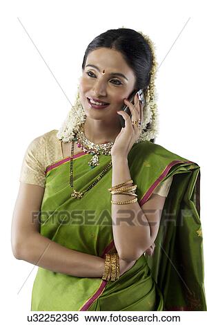 Stock Photograph - South Indian woman talking on a mobile phone . Fotosearch