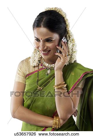 Stock Photograph - South Indian woman talking on a mobile phone . Fotosearch