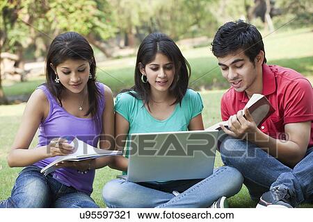 Students studying while sitting in lawn View Large Photo Image Stock Image - Students studying while sitting in lawn . Fotosearch