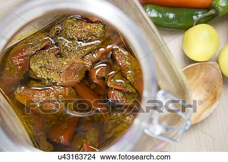 Picture - Stuffed red chilli pickle in a jar . Fotosearch
