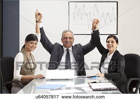 Stock Photo - Successful business people holding hands in office . Fotosearch