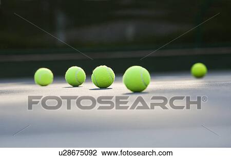 Surface level shot of tennis balls lying on ground View Large Photo Image Stock Image - Surface level shot of tennis balls lying on ground . Fotosearch