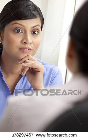 Surprised businesswoman listening to female executive View Large Photo Image Stock Photo - Surprised businesswoman listening to female executive . Fotosearch