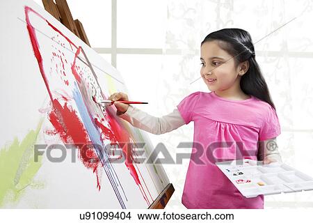 Sweet little girl painting on artist canvas during art class View Large Photo Image Picture - Sweet little girl painting on artist canvas during art class . Fotosearch