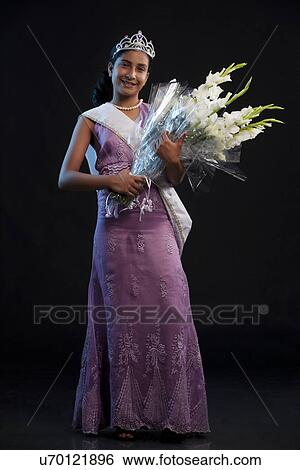 Teenage beauty queen holding a bouquet View Large Photo Image Stock Photograph - Teenage beauty queen holding a bouquet . Fotosearch