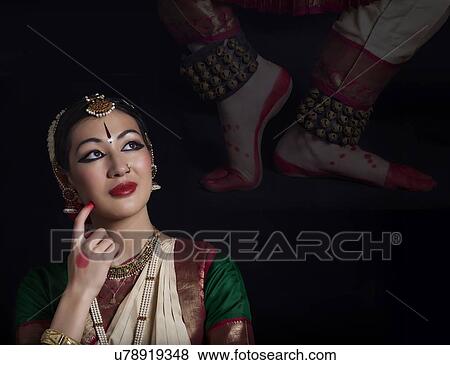 Stock Photo - Thoughtful Bharatanatyam dancer over black background. Fotosearch