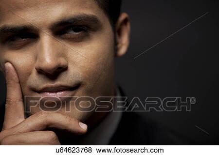 Thoughtful business man over black background View Large Photo Image Stock Photo - Thoughtful business man over black background . Fotosearch