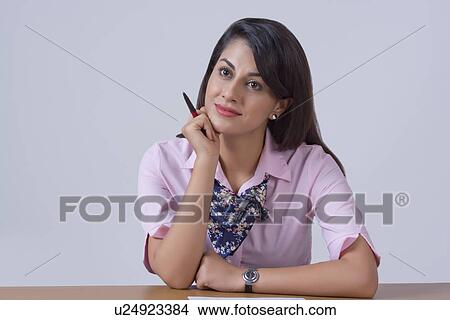 Thoughtful businesswoman leaning on office desk View Large Photo Image Picture - Thoughtful businesswoman leaning on office desk. Fotosearch