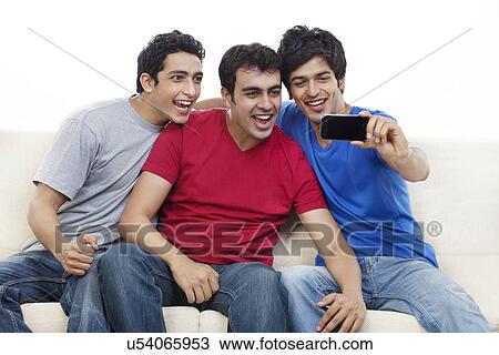 Stock Image - Three friends talking self portrait photograph . Fotosearch