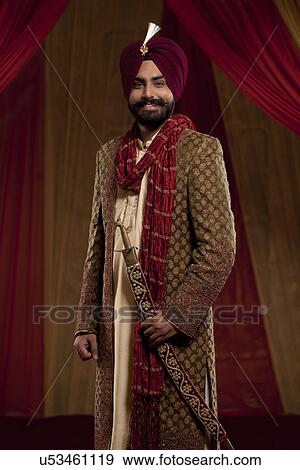 Three quarter length of mid adult man wearing wedding dress View Large Photo Image Stock Photo - Three quarter length of mid adult man wearing wedding dress . Fotosearch