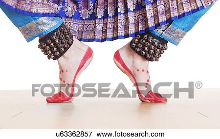 Stock Photo - Traditional dancer's feet performing Bharatanatyam over white background. Fotosearch