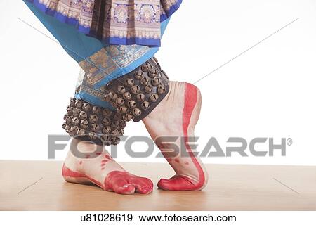 Stock Photo - Traditional dancer's feet performing Bharatanatyam over white background. Fotosearch