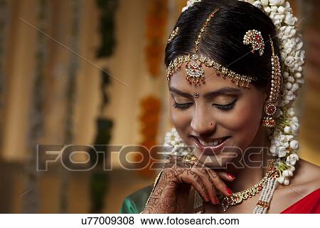 Traditional Indian woman looking down View Large Photo Image Stock Photo - Traditional Indian woman looking down . Fotosearch