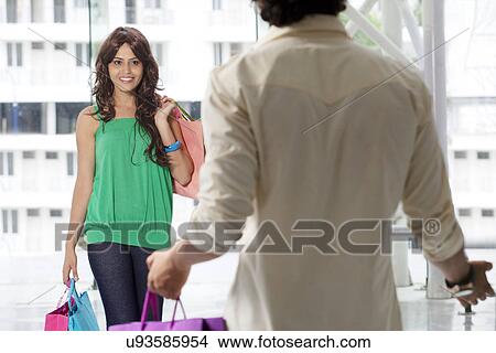 Two friends meeting at shopping mall View Large Photo Image Picture - Two friends meeting at shopping mall . Fotosearch