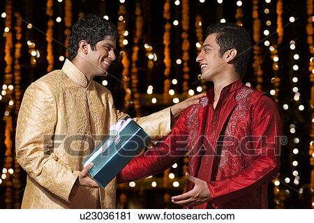 Two men exchanging gifts View Large Photo Image Stock Image - Two men exchanging gifts. Fotosearch