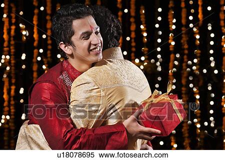 Two men hugging each other View Large Photo Image Stock Photography - Two men hugging each other. Fotosearch