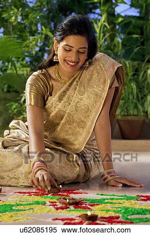 Woman arranging diyas View Large Photo Image Stock Photography - Woman arranging diyas . Fotosearch