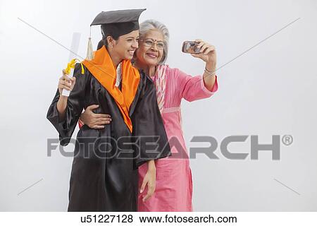 Stock Photo - Woman at granddaughter's graduation ceremony. Fotosearch