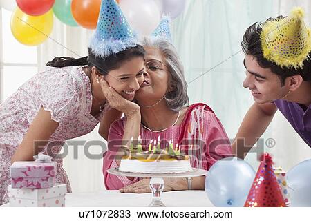 Woman celebrating birthday with grandchildren View Large Photo Image Stock Image - Woman celebrating birthday with grandchildren. Fotosearch