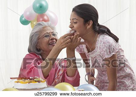 Woman celebrating birthday with granddaughter View Large Photo Image Stock Photo - Woman celebrating birthday with granddaughter. Fotosearch
