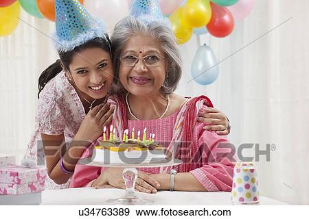 Woman celebrating birthday with granddaughter View Large Photo Image Stock Photo - Woman celebrating birthday with granddaughter. Fotosearch