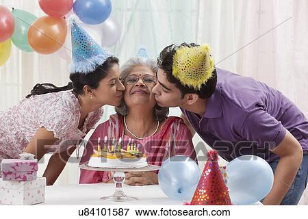 Woman celebrating birthday with grandchildren View Large Photo Image Stock Photo - Woman celebrating birthday with grandchildren. Fotosearch