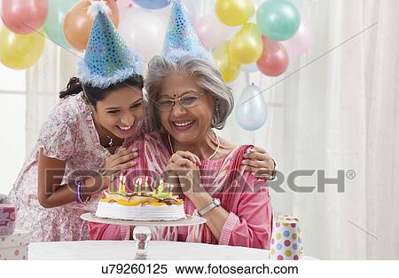 Woman celebrating birthday with granddaughter View Large Photo Image Stock Photography - Woman celebrating birthday with granddaughter. Fotosearch