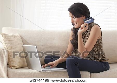 Woman doing net banking on laptop View Large Photo Image Stock Photo - Woman doing net banking on laptop. Fotosearch