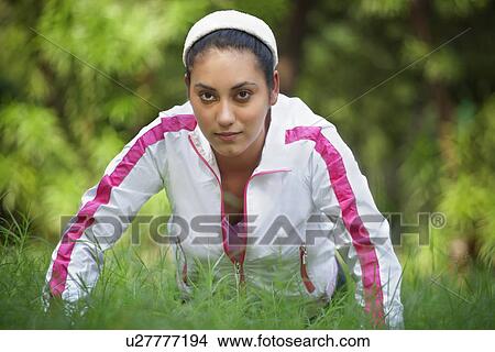 Woman doing push-up on grass View Large Photo Image Picture - Woman doing push-up on grass . Fotosearch