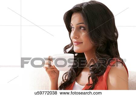 Stock Photo - Woman drinking a cup of coffee. Fotosearch