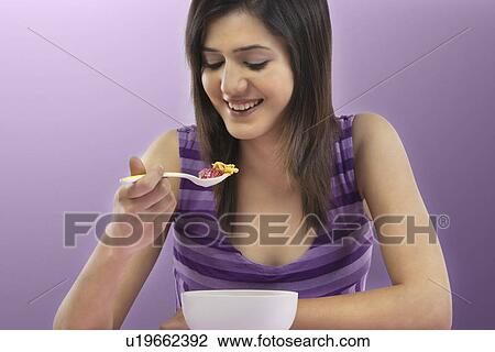 Woman eating breakfast View Large Photo Image Stock Image - Woman eating breakfast . Fotosearch